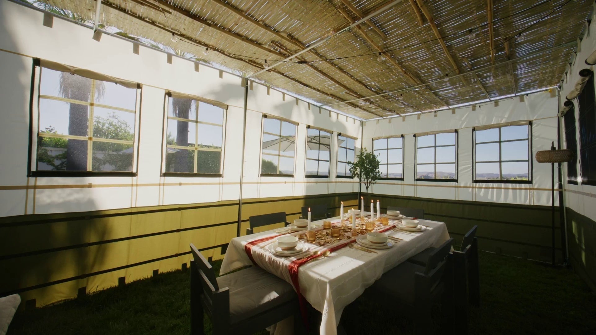 sukkah decorated with table set for sukkot