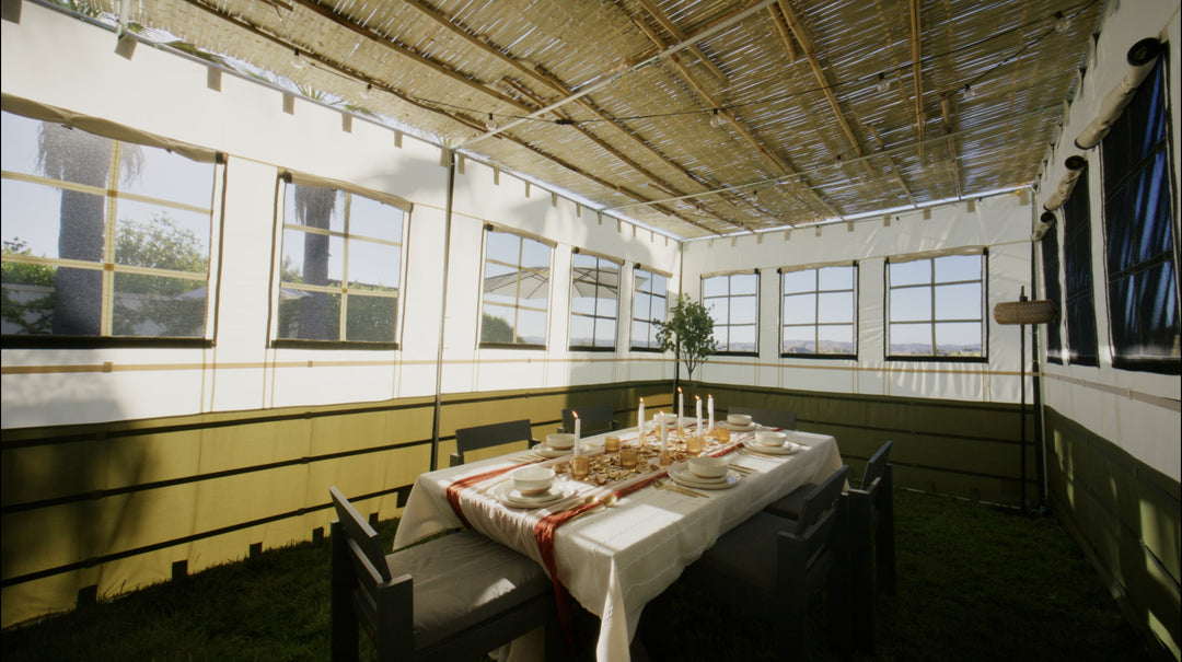 decorated sukkah with decorations and table setting